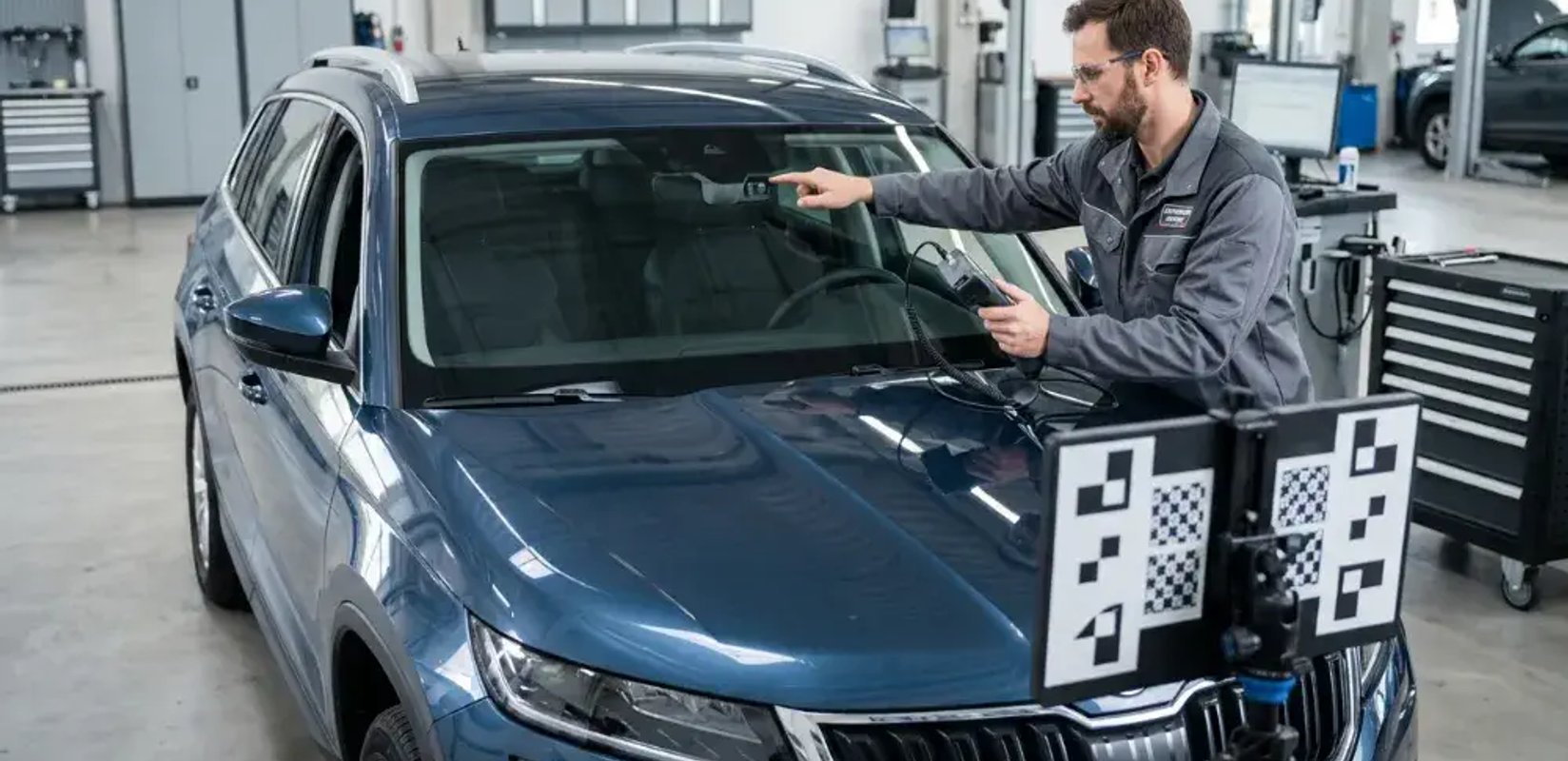 Technician performing ADAS calibration on a vehicle