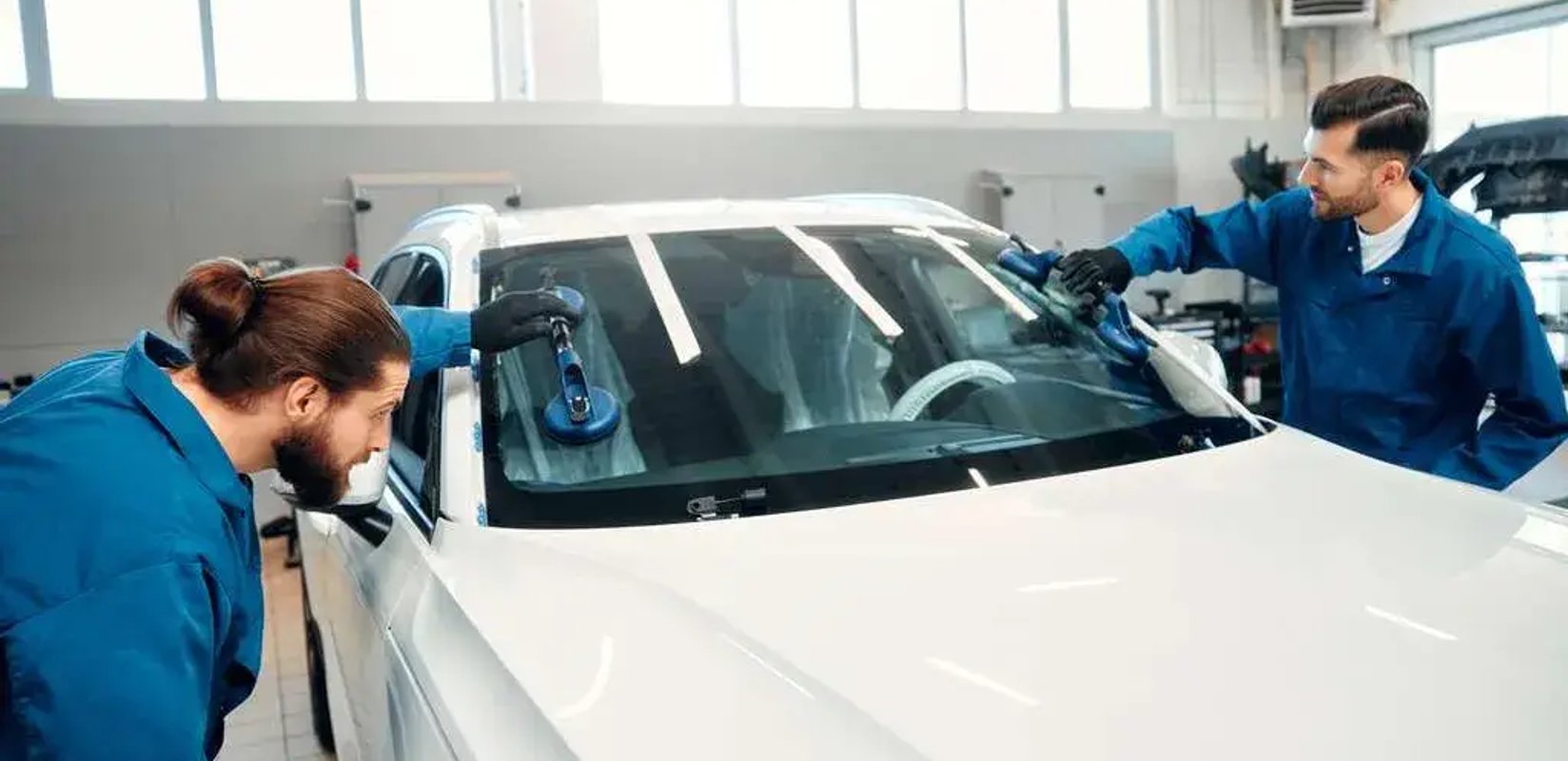 Auto glass technician replacing a windshield